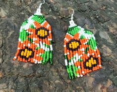 Orange flowers earrings, Summer flowers earrings, Floral seed bead earrings, summer jewelry, Mexican earrings, dangle earrings Handmade boho Size:  Length: 2.4 inches   (6.1 cm) Width: 1.2 inches   (3.2 cm) Materials: czech seed beads Flowers beaded earrings. Very lightweight. Fusion between ethnic style and modern elements. Earrings made of quality Czech seed beads. Cute handmade Earrings is a pleasant gift for you or for one you love. RECOMMENDATION FOR USE AND CARE:  - Do not clean with water and any other liquid. - Keep your handmade jewelry in a closed box far away from sun rays access. Thank you for your visit! Please, see my shop  https://www.etsy.com/shop/InnaPositiveArt Bohemian Orange Flower Beaded Earrings, Summer Beach Flower Earrings With Colorful Beads, Summer Flower Shaped Beaded Earrings With Dangling Beads, Summer Flower-shaped Beaded Earrings With Dangling Beads, Flower-shaped Earrings With Colorful Beads For Beach, Flower Shaped Earrings With Colorful Beads For Beach, Bohemian Beach Flower Earrings With Colorful Beads, Bead Patterns Free, Jewelry Mexican