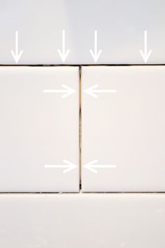 two white tiles with arrows pointing in opposite directions