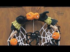 a crocheted halloween wreath hanging on a door