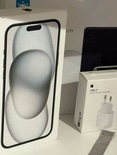 an apple iphone is in the box next to it's charger and packaging