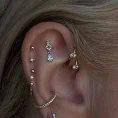 a woman wearing three different ear piercings