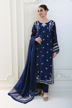 Meticulously crafted from a remarkably glamourous shade of navy blue ( pure raw silk 58 Gms )“ Tahzeeb “ with its intricate embroidered details strike the perfect balance between elegant and eye-catching, making this beautiful design a must have. The length of the long kameez is 46 inches.Order Duration: 4 to 6 weeks Blue Dresses With Resham Embroidery In Cotton Silk, Indigo Chanderi Traditional Wear For Wedding, Indigo Wedding Sets With Dupatta, Wedding Indigo Sets With Dupatta, Indigo Wedding Set With Dupatta, Blue Cotton Silk Dress With Zari Work, Indigo Chanderi Traditional Wedding Wear, Silk Blue Kurta With Resham Embroidery, Silk Kurta With Resham Embroidery In Blue