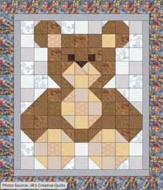 a teddy bear quilted on top of a table