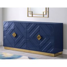 a blue and gold sideboard with geometric designs on the front, in a living room