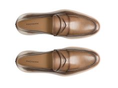 The Lalo showcases Magnanni's take on a sophisticated dress hybrid. This dapper slip-on features a traditional penny loafer design in supple calfskin leathers. The sleek dress silhouette is complemented with a comfortable and cushioned white rubber sole, making it the ideal selection for an on-the-go lifestyle. Luxury Calf Leather Slip-ons For Formal Wear, Luxury Slip-on Dress Shoes For Business Casual, Luxury Formal Wingtip Slip-ons, Luxury Slip-ons With Rubber Sole For Semi-formal Occasions, Luxury Leather Slip-ons, Luxury Semi-formal Slip-ons With Rubber Sole, Luxury Brogue Detailed Slip-ons For Formal Occasions, Luxury Formal Slip-ons With Brogue Detailing, Luxury Goodyear Welted Slip-ons For Formal Occasions