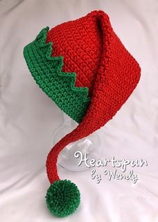 a crocheted christmas hat with a green pom - pom on top