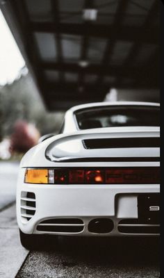 a white sports car parked in front of a building