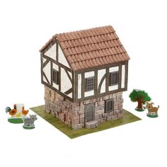 a toy house with animals around it