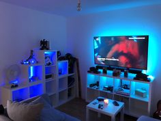 a living room filled with furniture and a flat screen tv mounted on the wall above it