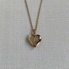 A child's plain polished 14K yellow gold-filled heart-shaped locket on a cable chain necklace. The outer shell is solid gold pressure-bonded to an inner core of high-quality brass. Locket Dimensions: 13 mm W x 21 mm H Chain Length: 15" Cable Chain Necklace, Heart Locket Necklace, Inner Core, Heart Locket, Locket Necklace, Cable Chain, Chain Lengths, Chain Length, Locket