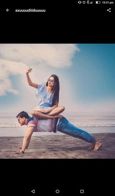 a man and woman doing yoga on the beach