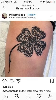 a black and white clover tattoo on the left thigh, with an arrow in the middle