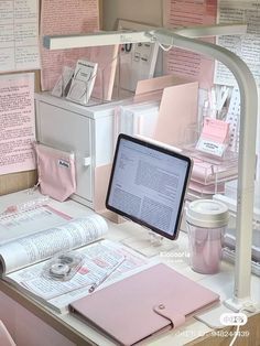 a desk topped with lots of pink items