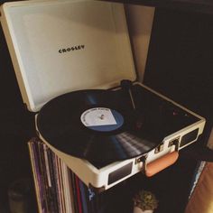 a record player sitting on top of a shelf