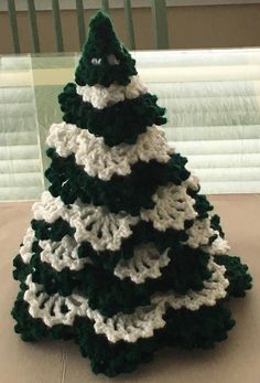 a crocheted christmas tree sitting on top of a table