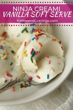 a white bowl filled with vanilla frosting and sprinkles