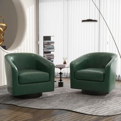 two green chairs sitting on top of a rug in a living room next to a lamp