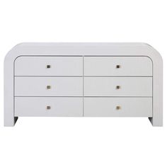 a white dresser with gold handles and drawers