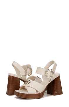 Gleaming logo hardware tops the crisscross straps of this summery sandal elevated by a stacked block heel and subtle platform. 3 1/2" heel Synthetic upper, lining and sole Imported Summer T-strap Sandals With Block Heel And Heel Loop, Beach T-strap Sandals With Toe Loop And Heel Strap, Beach Sandals With Cork-bed Midsoles And Block Heel, Chic Synthetic Cross-strap Sandals, Cream Sandals With Heel Loop, Medium Width, Heel Sandal, Sandal Women, Block Heels Sandal, Nordstrom Rack