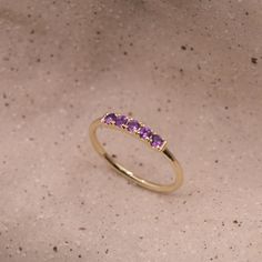 Our popular Candy Ring is gorgeous in a vintage style and set with Amethyst. The ring is 14k gold and has an stunning row of black stones decorated on the top face of the ring. It is delicate and dazzling while showing off some serious sparkle. This ring can be customized with any stones of your liking. Check out our size chart to find the perfect size for you! All features can be customized! Talk to us, we love making custom designs. Our jewelry is carefully handmade in our atelier Our diamonds 14k Yellow Gold Amethyst Ring With Accent Stones, Yellow Gold Amethyst Birthstone Ring, Heirloom Amethyst Ring In Yellow Gold, Heirloom 14k Gold Amethyst Ring With Accent Stones, Heirloom Amethyst Ring Stamped 14k, Elegant Yellow Gold Amethyst Ring With Round Band, Heirloom Yellow Gold Amethyst Ring With Round Cut, Heirloom Yellow Gold Amethyst Ring, Fine Jewelry 14k Gold Amethyst Ring With Round Cut