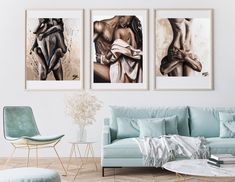 three paintings hang on the wall above a blue couch