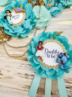 two disney princess brooches are sitting on top of each other, with the words daddy