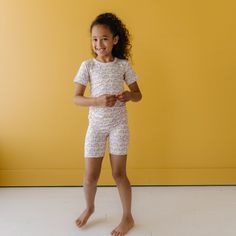 Image of little girl wearing a rainbow printed short sleeve and shorts pajama set. This print features multicolored rainbows that sit upon a white background with light pink accent trim. Pretty Swimwear, Pajamas All Day, Kids Pjs, Accent Trim, Go To Bed, Pink Trim, Children's Boutique, Friend Outfits, Rainbow Print