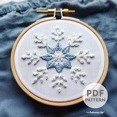 an embroidered snowflake is shown in the hoop