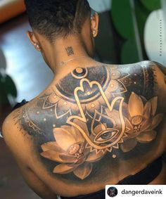 the back of a woman's body with tattoos on her upper and lower half