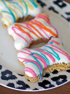 there are two donuts on the plate with icing and sprinkles