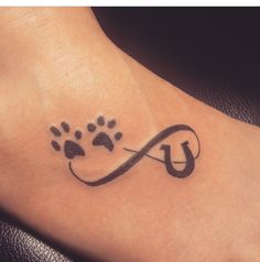 a dog's paw with an infinite sign tattoo on its foot