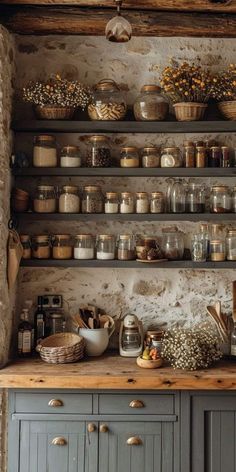 an old kitchen with lots of pots and pans on the shelves, including one potted plant