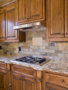 a stove top oven sitting inside of a kitchen next to wooden cupboards and cabinets