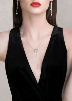 Get on trend with our IZZY lariat finest imitation pearl drop necklace. Made with the finest quality crystals and pearls, this modern piece of jewelry can be adjusted to any desired length and can be worn in the front or back. This necklace is available in bright silver or bold gold. Pair it with a deep plunging neckline, an open back top or gown. It truly is the perfect accessory to wear for any occasion. This simple yet elegant necklace is made with nickel-free metal and measures 24 inches lon Silver Lariat Necklace With Pearl Drop, Silver Lariat Necklace With Pearl Chain, Silver Minimalist Lariat Pearl Necklace, Minimalist Silver Lariat Pearl Necklace, Sterling Silver Lariat Necklace With Pearl Drop, Sterling Silver Lariat Necklace With Pearl Pendant, Elegant Pearl Pendant Lariat Necklace, Sterling Silver Drop Necklace For Parties, Elegant Backdrop Necklace With Pearl Charm