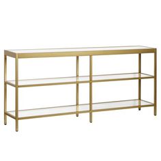 a gold and glass console table with shelves