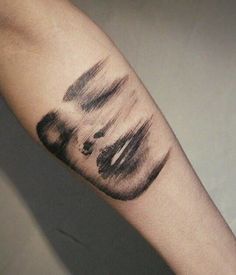 a black and white photo of a person's arm with an inked design on it