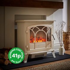 a white stove sitting on top of a wooden floor next to a pile of logs