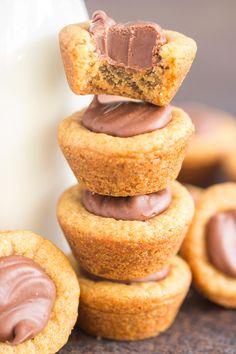 chocolate frosted cookies stacked on top of each other next to a glass of milk