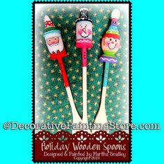 three toothbrushes decorated with snowmen and santa claus on them, sitting next to each other