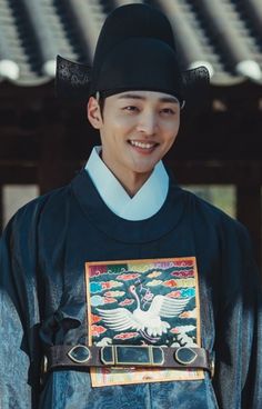 a young man wearing a black hat and blue shirt with an eagle on it's chest