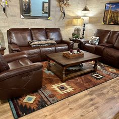 a living room filled with brown leather furniture