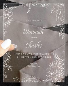 a person holding a piece of paper with the words, wedding and charles written on it