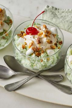 three desserts with cherries and whipped cream