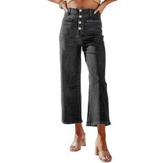 a woman is wearing high waist jeans and a cropped top with buttons on the side