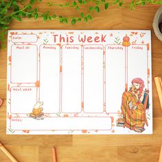 this week planner is sitting on top of a wooden table next to some pencils