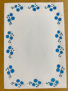 a piece of paper with blue dots on it