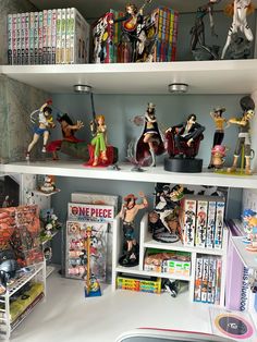 shelves filled with figurines and toys on top of a white countertop in a room