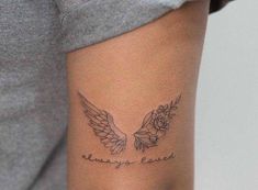 a woman with a tattoo on her arm that says, always love and two wings