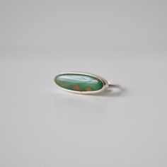 This natural turquoise from Nevada has a lovely grass green color with some light brown inclusions to add some visual interest. Skinny oval shaped cabochon is set horizontally in a simple handcrafted stacker ring setting. .925 Sterling Silver Size 6 Top measures approximately 7mm x 20mm *Only ONE available Great alone or paired with friends! Horizontal Gemstone Ring, Turqoise Ring, Gem Studio, Grass Green Color, Dream Accessories, Metalsmithing Jewelry, Stacker Rings, Turquoise Ring Silver, Stacked Jewelry