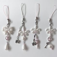 four charms with bows and hearts hanging from them